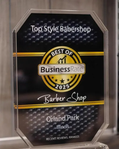The Best of 2025 BusinessRate award for Top Style Barbershop, Orland Park, Illinois, on a glass stand