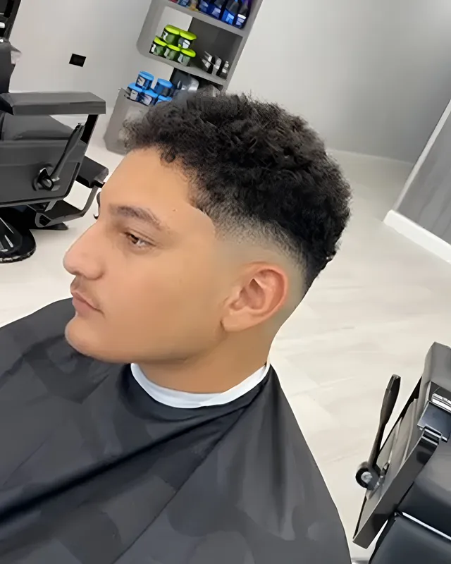 Curly top with a low taper, cut at Top Style