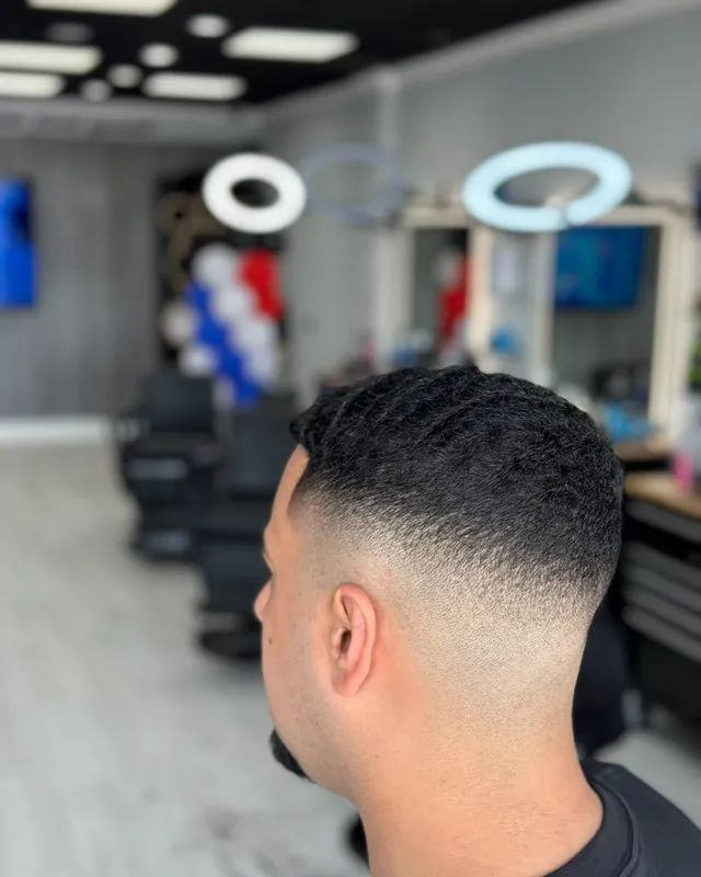 Mid skin fade with waves, cut at Top Style