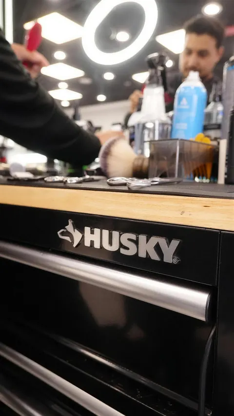 A barber station with sprays, combs and a black Husky tool chest