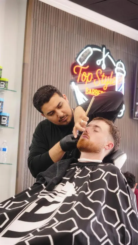 Client laid back in the chair for a nose wax, the neon sign glowing behind