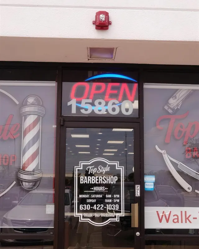The front door of Top Style Barbershop with the red OPEN sign and 15860 above it